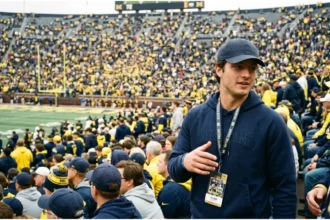 CJ Carr sitting in the stands at Michigan Stadium during the Indiana vs Michigan game.