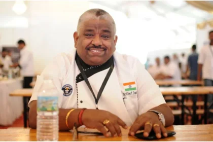 Chef Damodharan smiling while judging contestants on the Tamil TV show Cooku with Comali