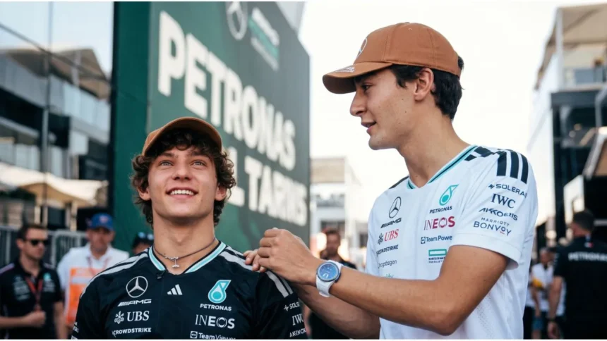 George Russell and Kimi Antonelli smiling during a fan forum in Austin