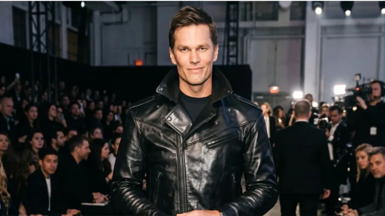 Tom Brady standing in a stadium with a smile, rumored to be dating Victoria's Secret Angel Candice Swanepoel