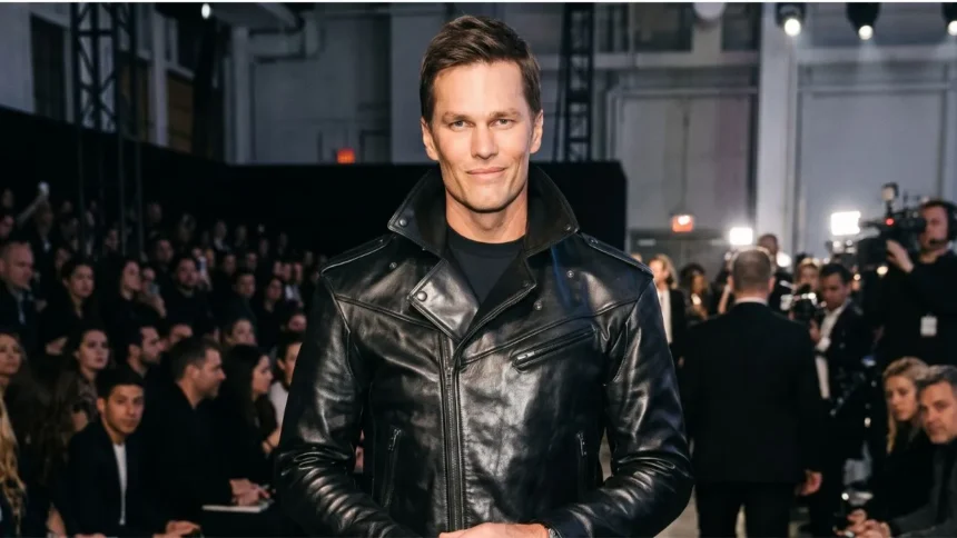 Tom Brady standing in a stadium with a smile, rumored to be dating Victoria's Secret Angel Candice Swanepoel