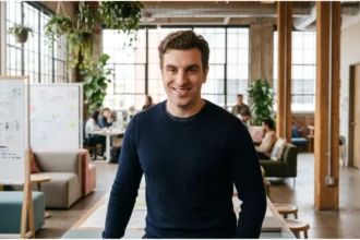 Brian Chesky, co‑founder and CEO of Airbnb, speaking into a microphone during a podcast interview about AI and management