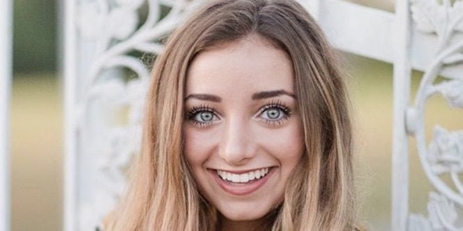 Brooklyn McKnight smiling while filming a family vlog with her twin sister Bailey