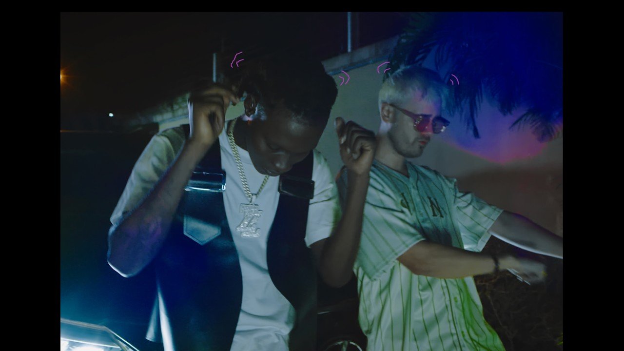 joki and Zinoleesky posing next to a white van with gold bars painted on it, Lagos city background, photographed by Daniel Kivle