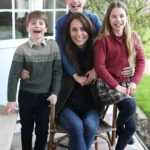 Prince William, Princess Kate, Prince George, Princess Charlotte, and Prince Louis standing together in a green landscape after the Three Peaks Challenge, wearing matching jeans and sneakers.