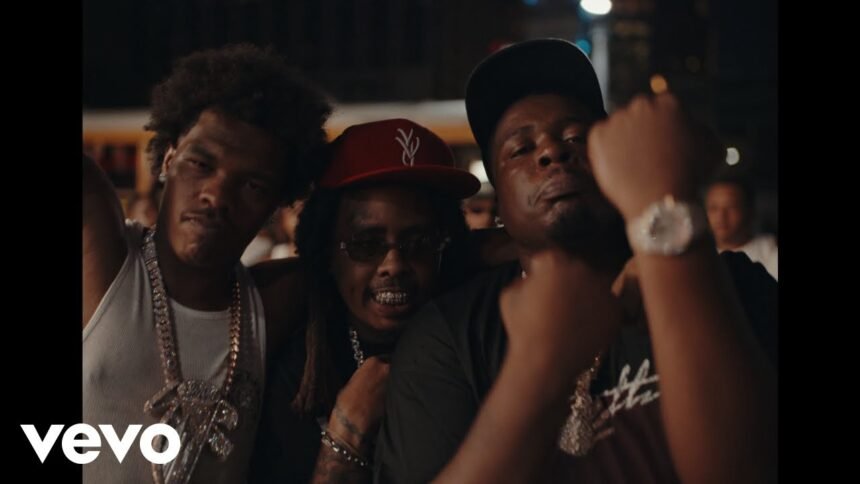 Screenshot of Lil Baby, Bally Baby, and Fatt Smaxk standing beside a vintage car on the Coast 2 Coast music video set.