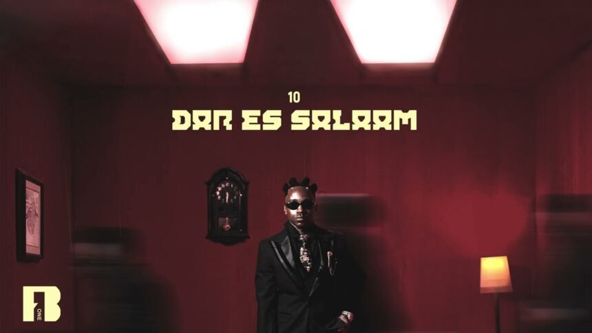 Ibraah on stage singing Dar Es Salaam with a city backdrop, wearing a casual outfit, microphone in hand