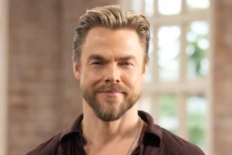 Derek Hough smiling alongside his late dog Romie in a sweet tribute photo.
