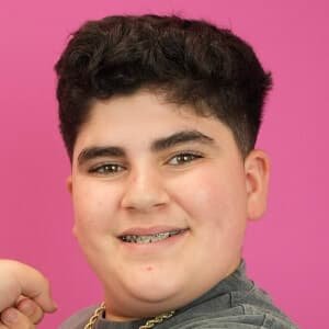 Eric Befumo, a teenage TikTok star known as Big Justice, smiling while holding a Costco food tray