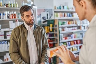 Young employee with a blank, unresponsive gaze, illustrating the Gen Z stare phenomenon in a retail setting.