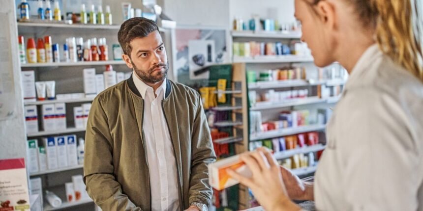 Young employee with a blank, unresponsive gaze, illustrating the Gen Z stare phenomenon in a retail setting.
