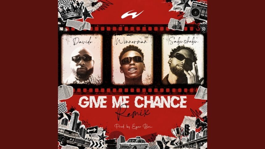 Winnerman on stage singing 'Give Me Chance (Remix)' with Sabushebu and Davido appearing on large screens behind him during a live performance.