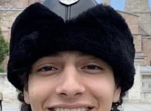 HamzahTheFantastic smiling while filming a TikTok comedy video in a bright room