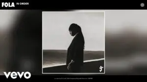 FOLA posing during a photo session for his album 9