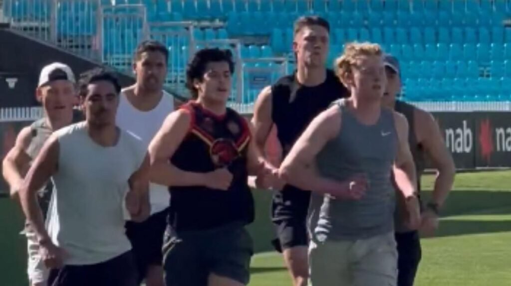 Isaac Keeler in a Port Adelaide training shirt, running drills on the field.