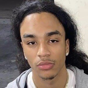 Portrait of rapper Jay Cinco wearing a casual hoodie, standing on a street in Los Angeles