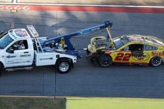 Joey Logano stock car upside down on its roof during Talladega wreck