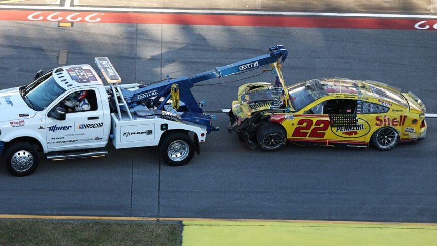 Joey Logano stock car upside down on its roof during Talladega wreck