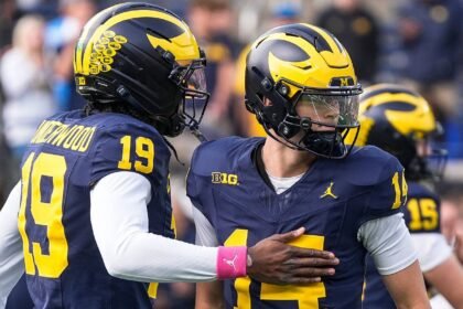 Michigan quarterback Tommy Carr (14) embraces Bryce Underwood (19) on the field before the Michigan vs Indiana game at Michigan Stadium, Ann Arbor, Oct. 24, 2026.