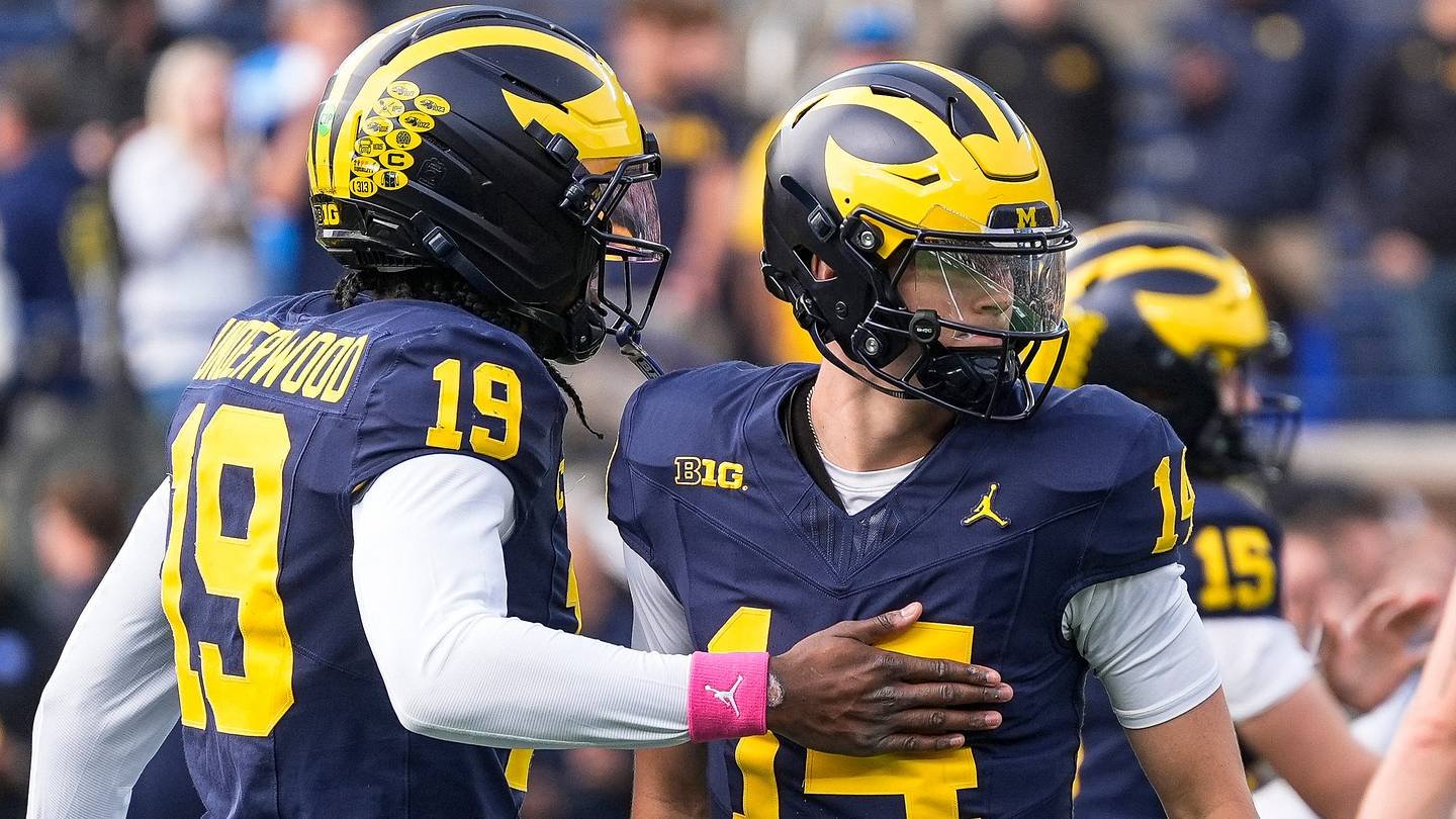 Michigan quarterback Tommy Carr (14) embraces Bryce Underwood (19) on the field before the Michigan vs Indiana game at Michigan Stadium, Ann Arbor, Oct. 24, 2026.