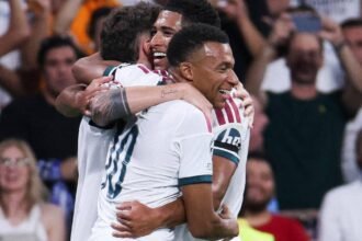 Kylian Mbappe running in celebration during the Barcelona versus Real Madrid match at Camp Nou.