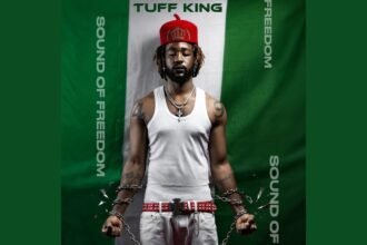 Live performance of TUFF KING singing 'Sound of Freedom' on stage with bright lights and an engaged audience.