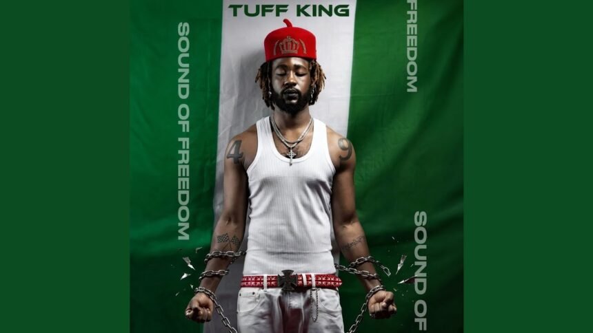 Live performance of TUFF KING singing 'Sound of Freedom' on stage with bright lights and an engaged audience.