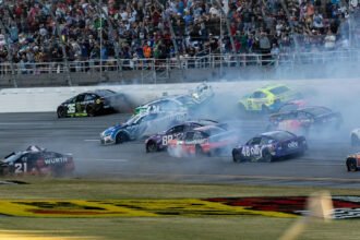Kyle Larson's No. 5 Chevrolet crossing the finish line at the YellaWood 500 in Talladega Superspeedway, with a close finish over William Byron.
