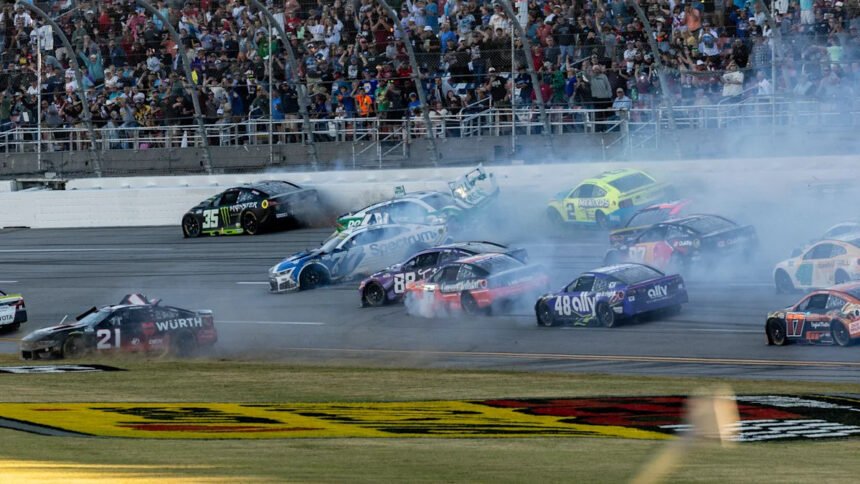 Kyle Larson's No. 5 Chevrolet crossing the finish line at the YellaWood 500 in Talladega Superspeedway, with a close finish over William Byron.