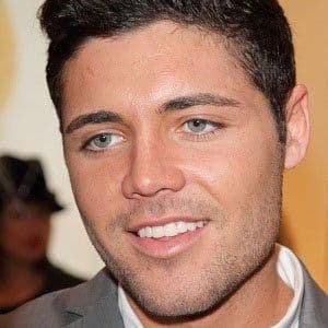 Tom Pearce, 36-year-old English reality TV star, smiling at a public event