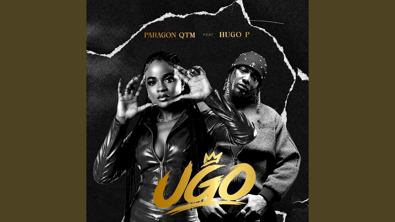 Paragon Qtm and Hugo P on stage during a live performance of the song Ugo, with bright stage lighting and audience in the background.