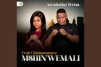 Mshinwemali on stage with vibrant lighting, holding a microphone, delivering his song Ukwamukela