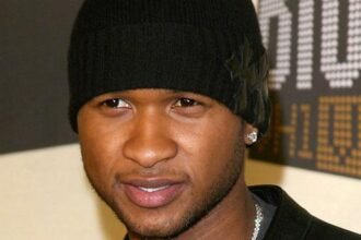 Usher singing on stage during the 2024 Super Bowl halftime performance