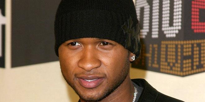 Usher singing on stage during the 2024 Super Bowl halftime performance