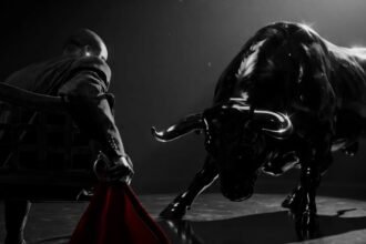 Fireboy DML on stage singing ZUKO! with bright stage lighting behind him